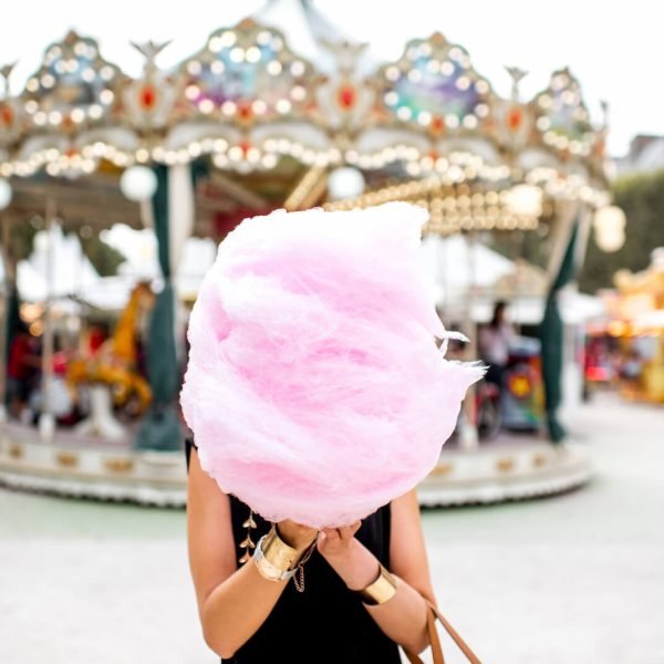 Canva - Woman with Cotton Candy at the Amusement Park(1)