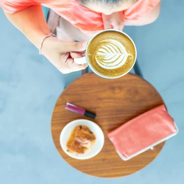 top-view-photography-of-a-woman-holding-coffee-cup-1023159